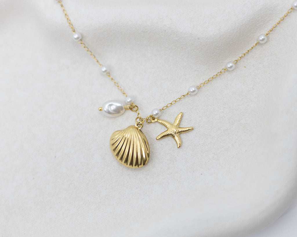 sea themed bracelet with charms on white plate