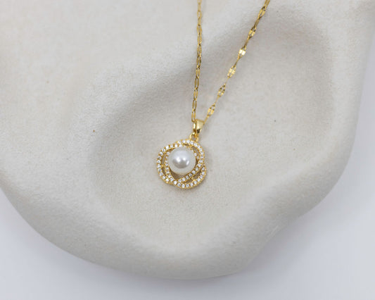 gold necklace with pearl and crystals on white background