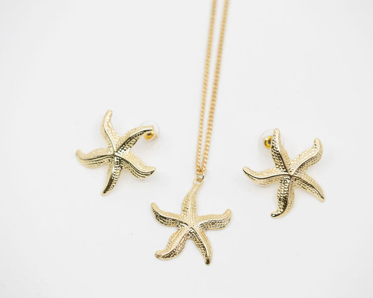 Gold starfish necklace and earrings on a white background
