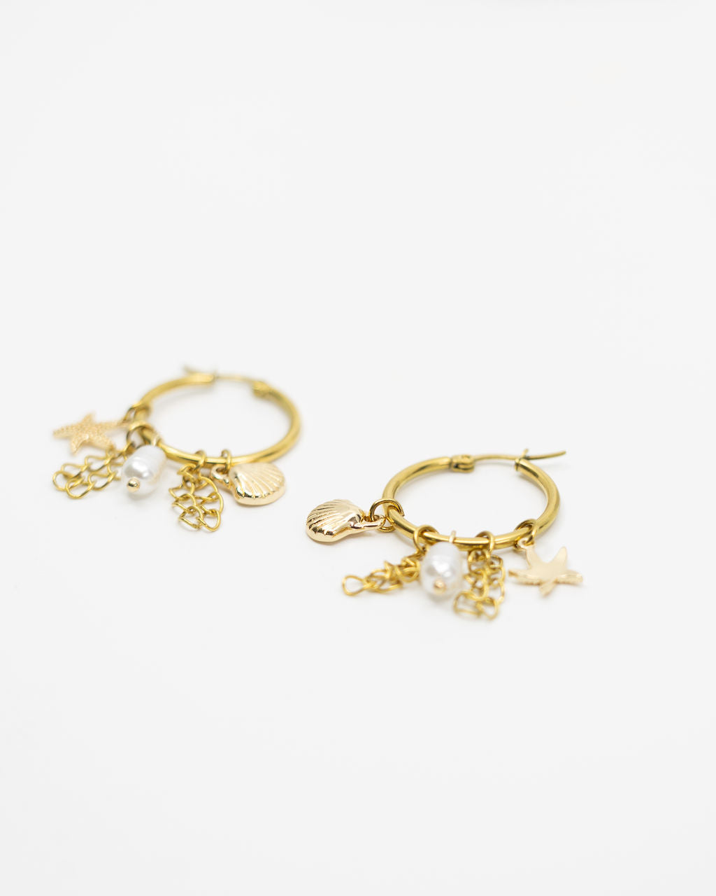 Gold hoop earrings with charms on a white background