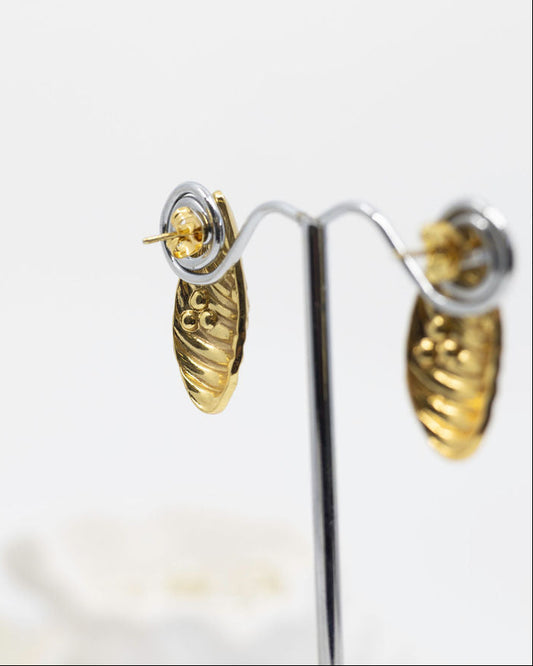 Gold earrings on a white background