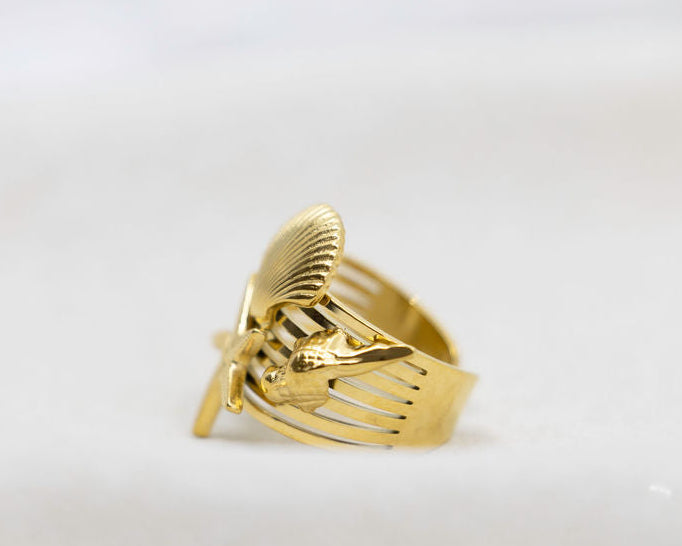 Gold ring with a unique design on a white background