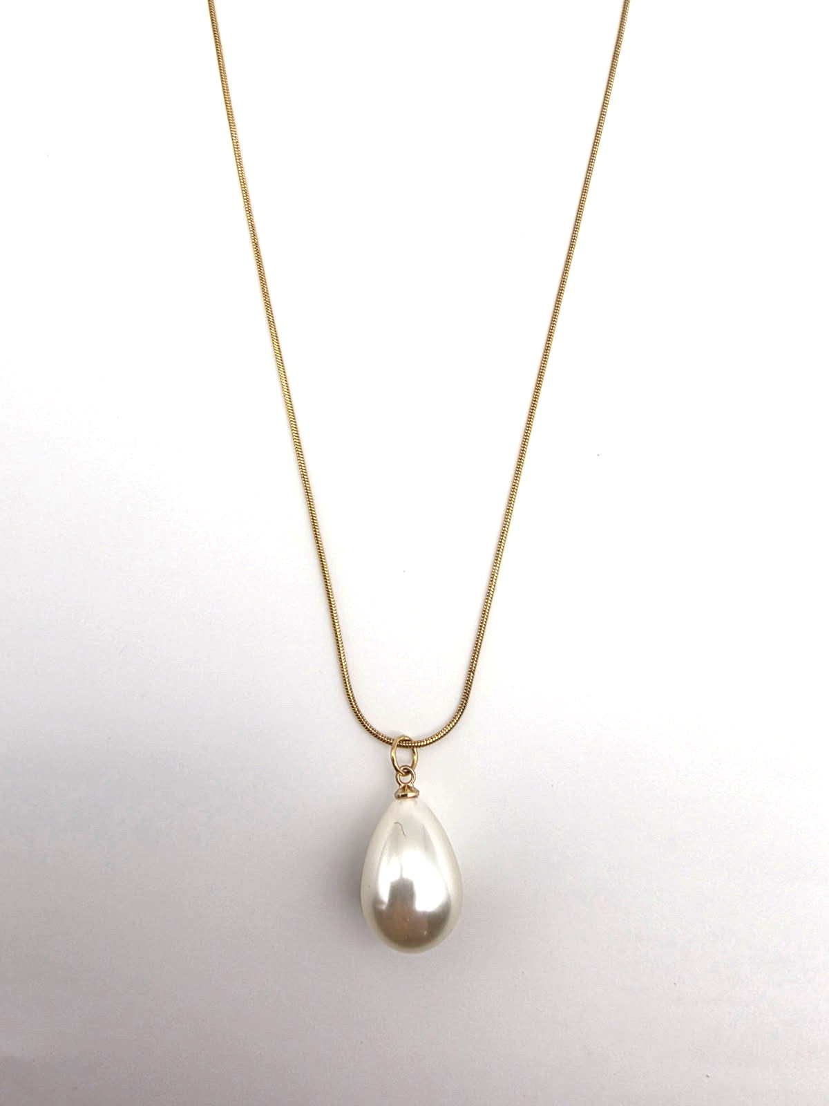 Pearl necklace on a gold chain against a white background