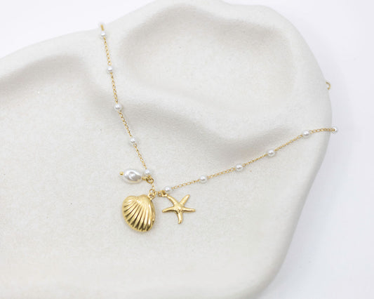 sea themed bracelet with charms on white plate