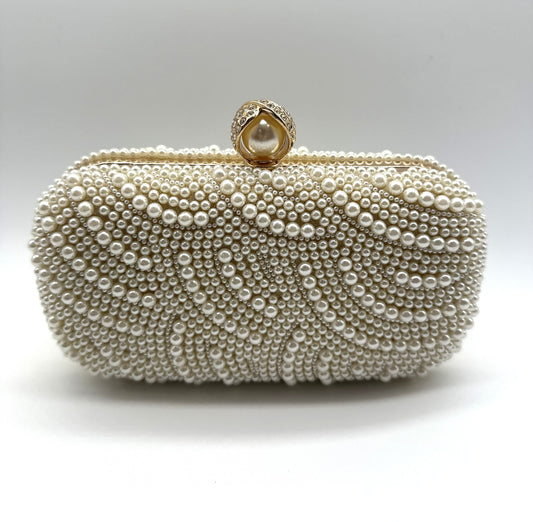 Pearl embellished clutch bag on a white background