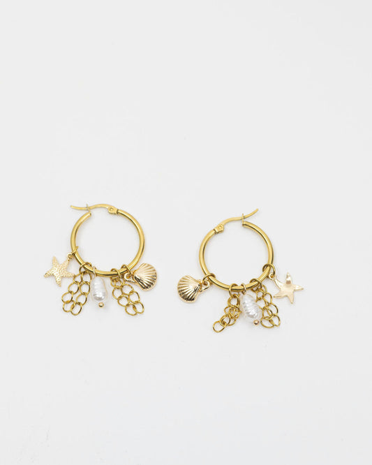 Gold hoop earrings with charms on a white background