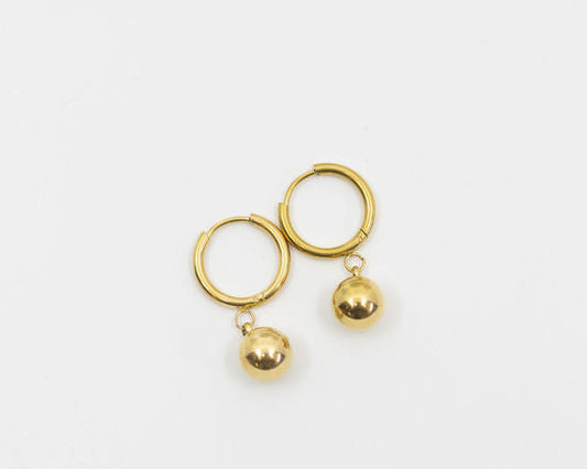 Gold earring with hoops and two gold ball drops on a white background