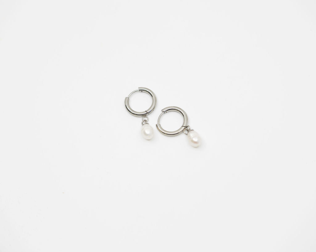 Gold hoop earrings on a light gray background