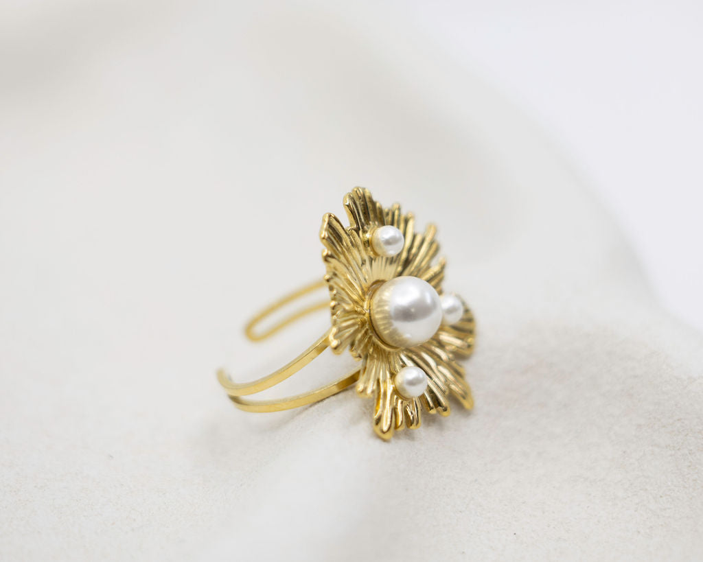 Gold ring with pearls on a white background