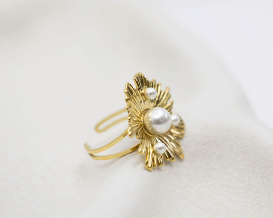 Gold ring with pearls on a white background