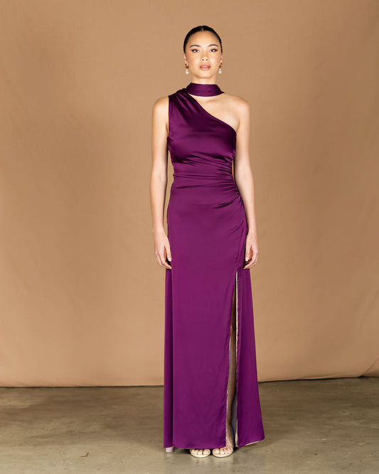Woman wearing a purple one-shoulder gown, one shoulder gown, reversible dress